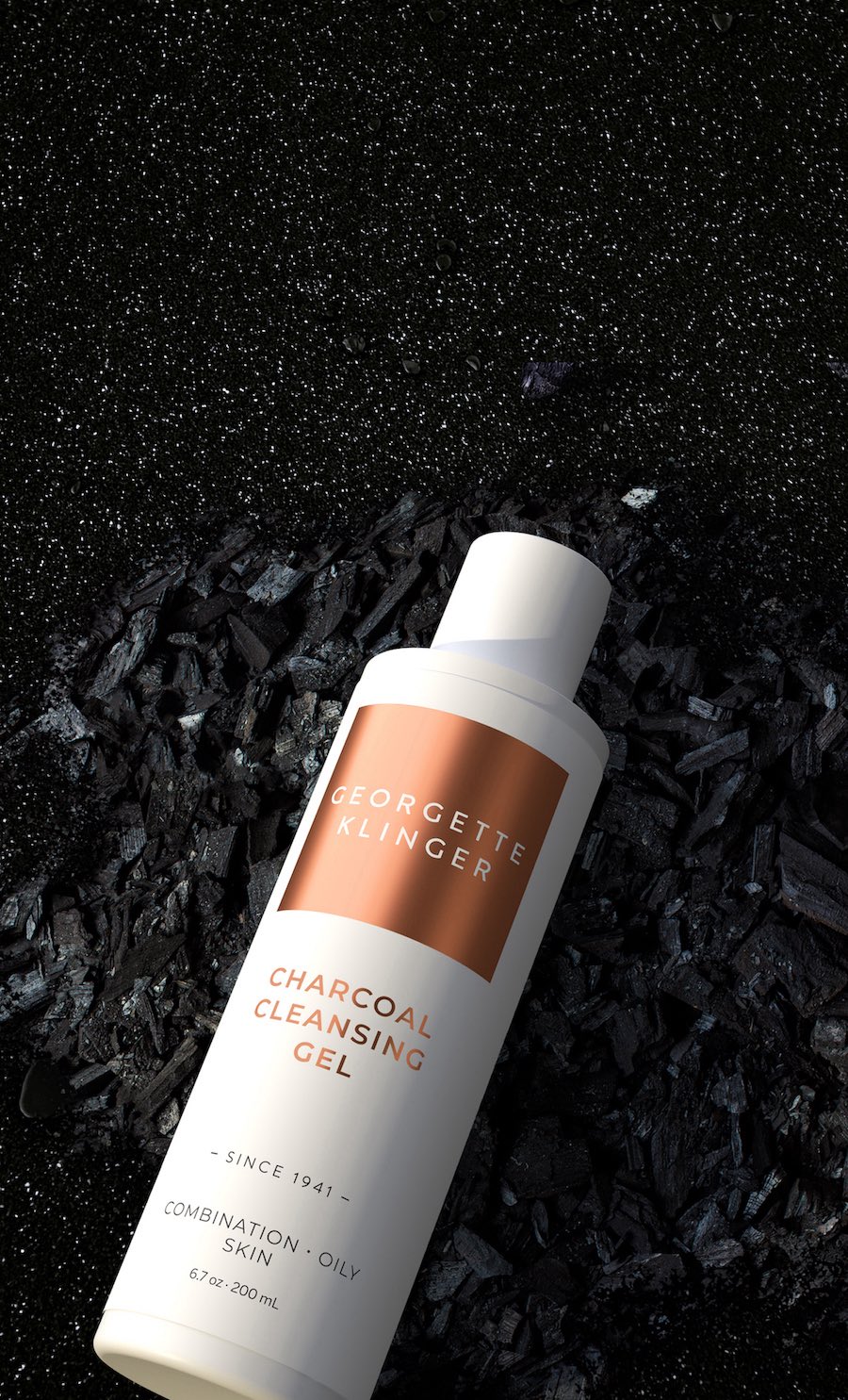 3d rendered Georgette Klinger skincare product bottle flat lay on charcoal dust.