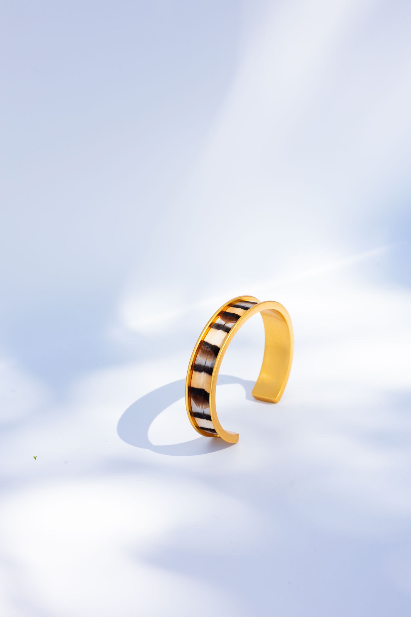 Staged women's gold bracelet photography