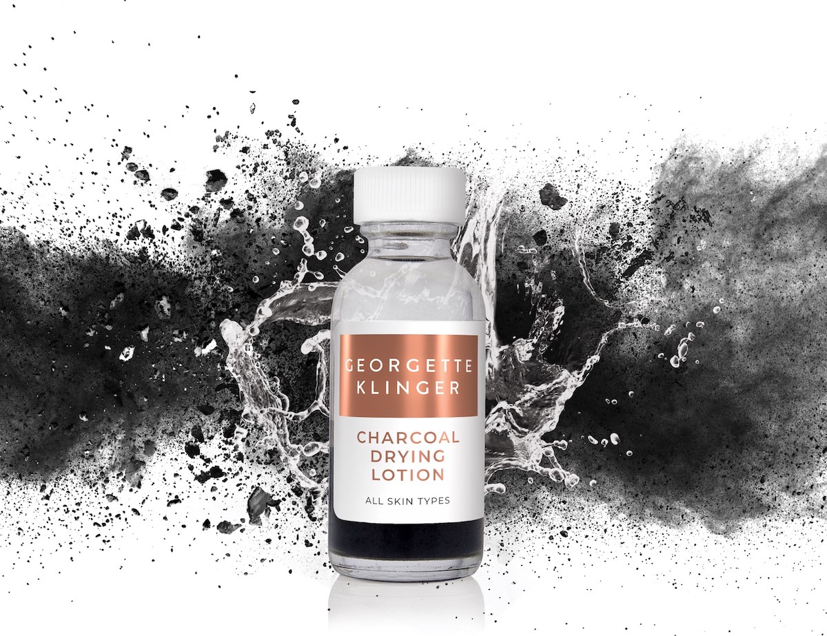 A 3D Rendered Skincare Bottle with photoshopped stock images of water splashing & charcoal dust. For Georgette Klinger