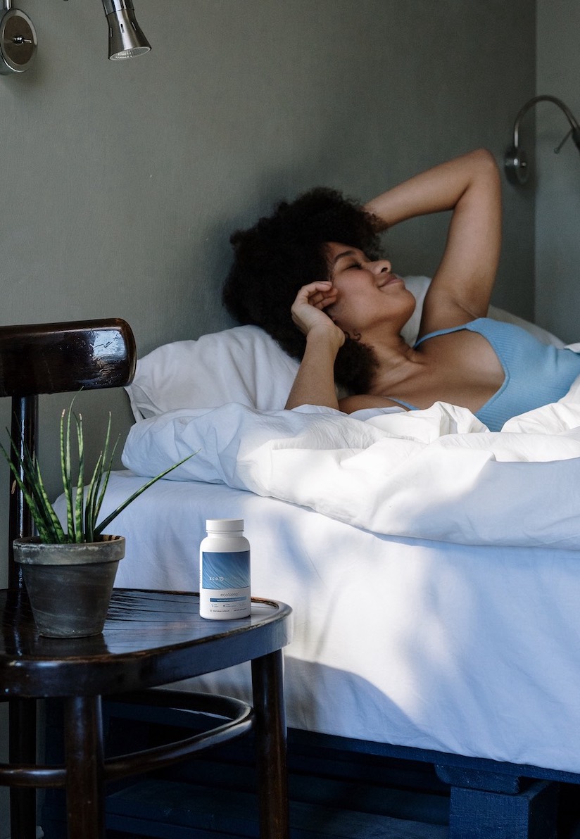 A photorealistic 3d render of supplement bottle on woman's bedside table.