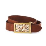 A men's belt that is neatly coiled up on a white background.