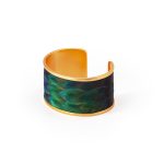 The front angle of a women's gold wide cuff bracelet on a white background.