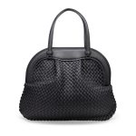 The front angle of a women's black handbag on a white background.