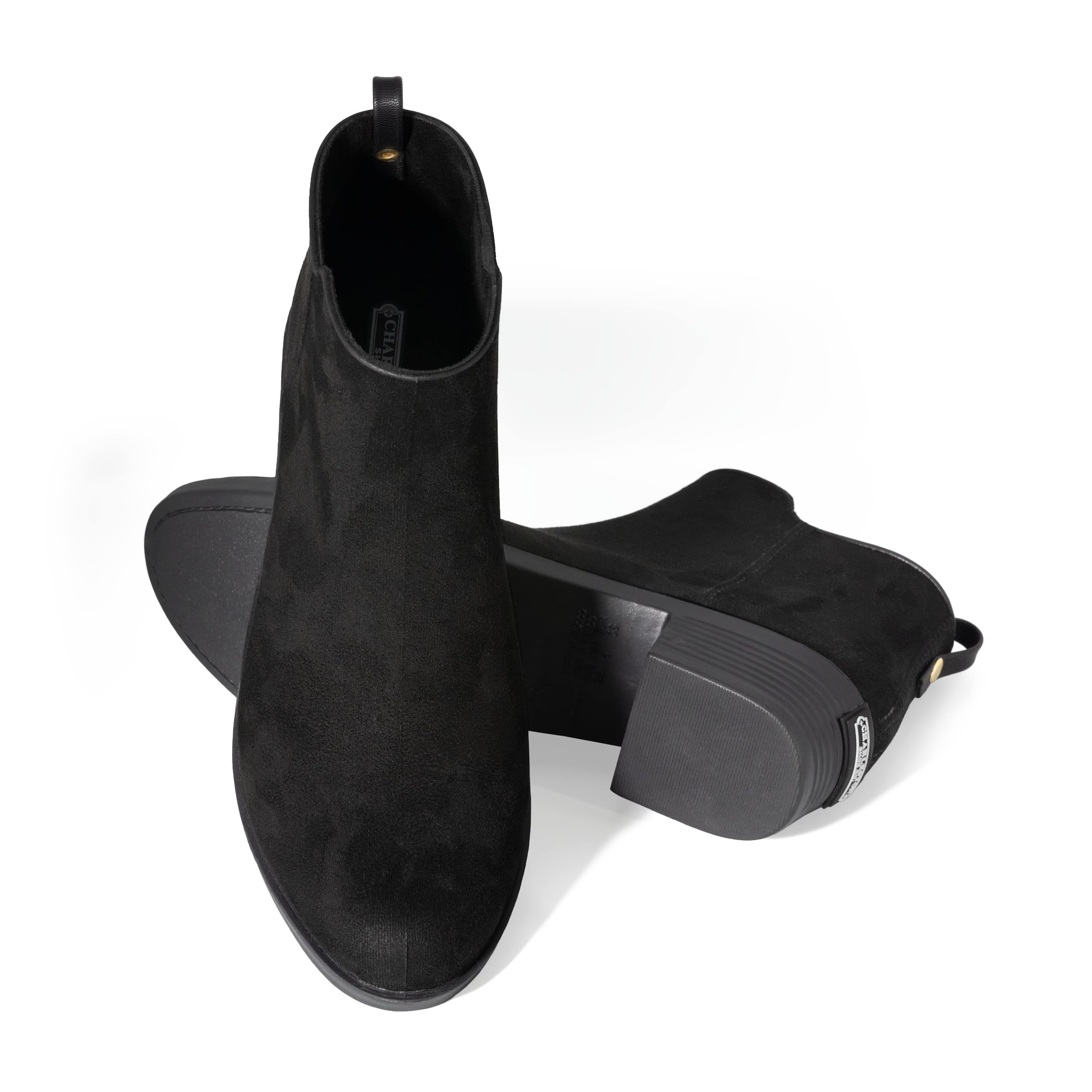 A posed angle of a Charleston Shoe black heeled boot.
