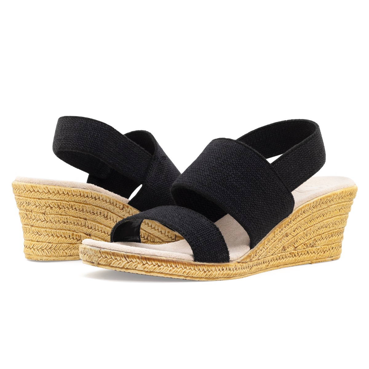 A posed angle of a Charleston Shoe Co. wedge summer sandal on a white background for Zappos.
